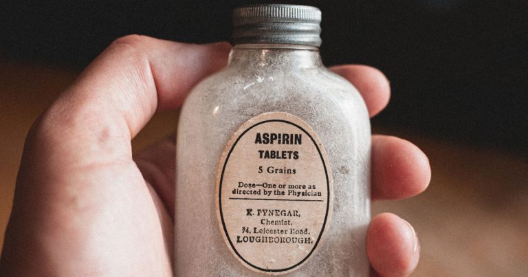 Antique Aspirin bottle for article entitled, Symptoms and disease control may be sufficient (and outcomes including survival superior) on lower drug doses than marketed, because of greater safety. Photo by Dan Smedley on Unsplash